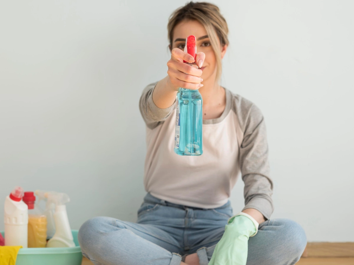 A woman holding a strong drain cleaning chemical
